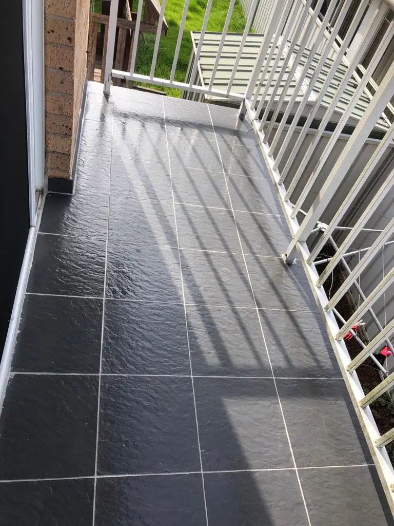 After: renewed grout and a sealed finish.